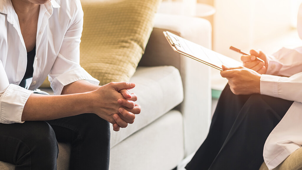 A patient and healthcare professional discussing integrative cancer care